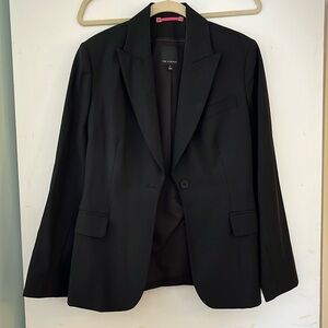 Timeless black blazer with a slightly nipped in waist that hugs curves